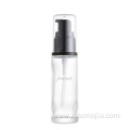 Empty round glass lotion bottle with pump